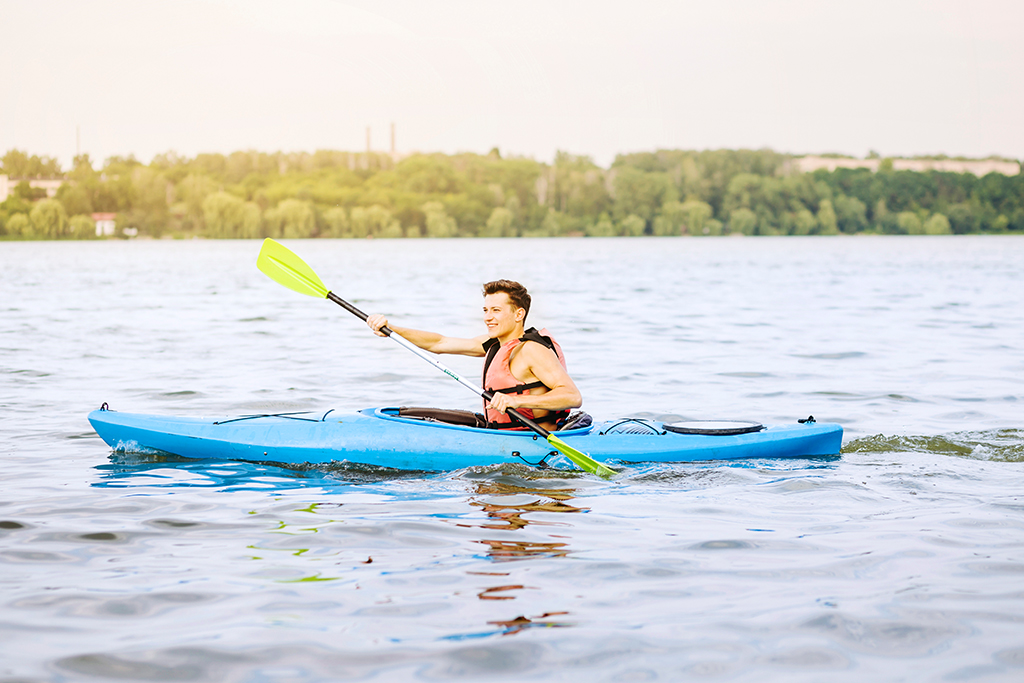 Traveler enjoying a kayaking adventure on calm waters